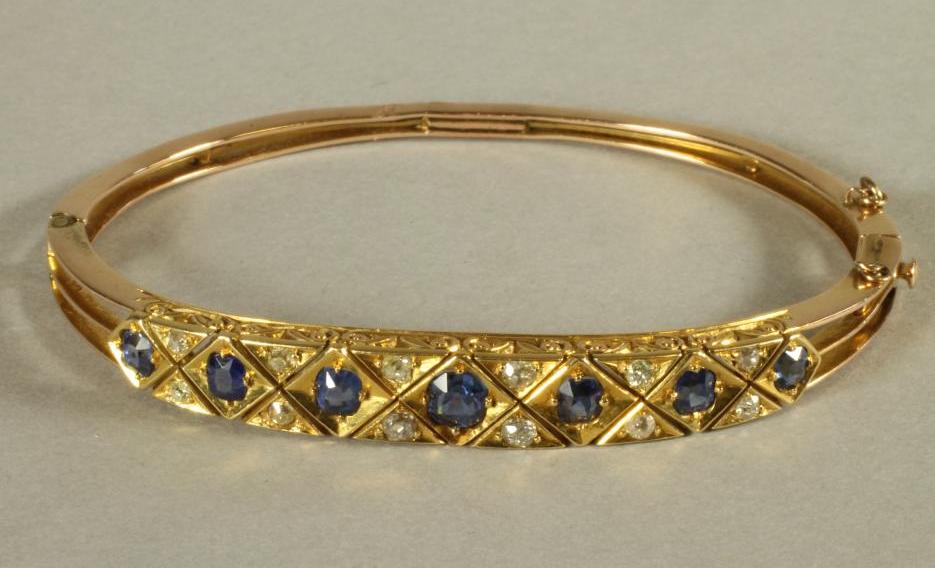 A VICTORIAN SAPPHIRE AND DIAMOND SET STIFF HINGED BANGLE Image