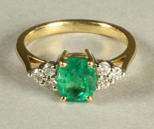 AN EMERALD AND DIAMOND RING Image