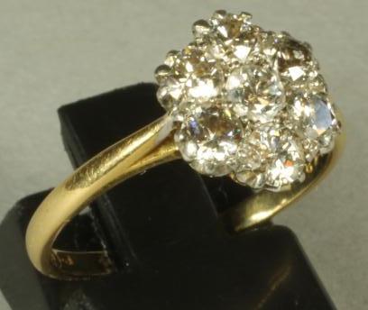 A SEVEN STONE DIAMOND CLUSTER RING Image