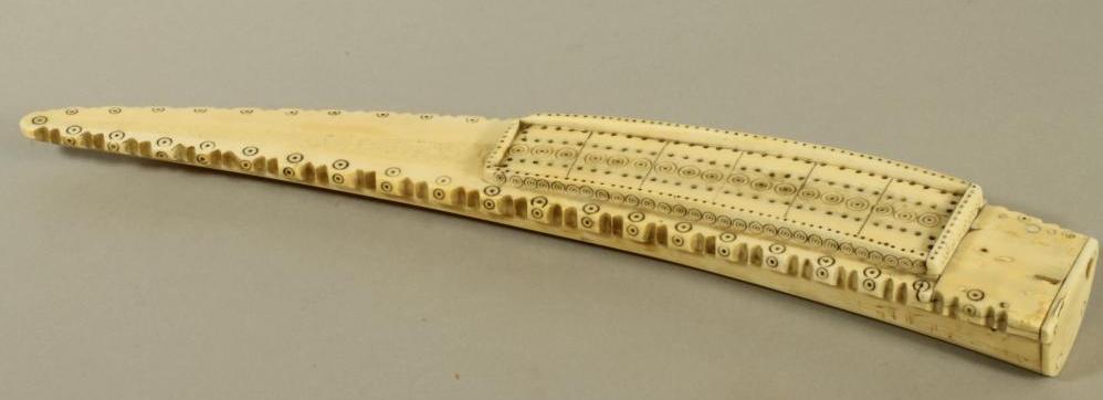 A WALRUS TUSK SCRIMSHAW CRIBBAGE BOARD Image