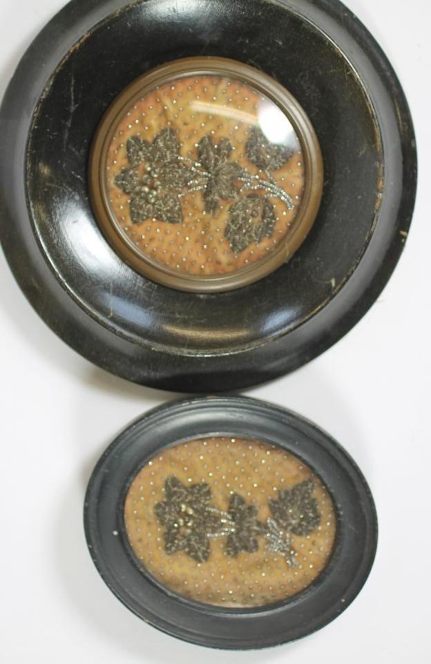 A VICTORIAN ORMOLU SMALL PLAQUE cast as a cupid kneeling within a full blown rose Image