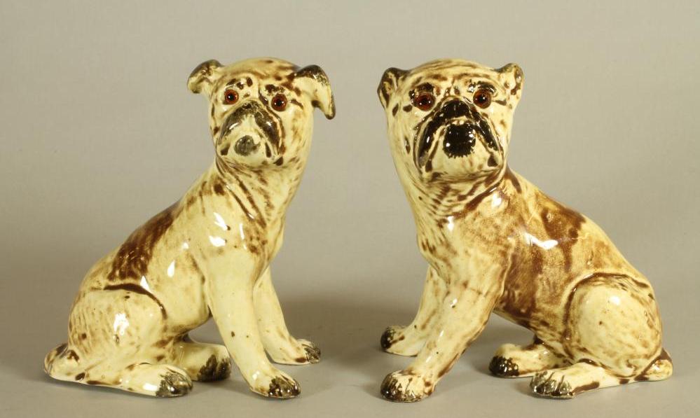 A MATCHED PAIR OF CONTINENTAL CREAMWARE SLIP CAST MODELS OF PUGS Image
