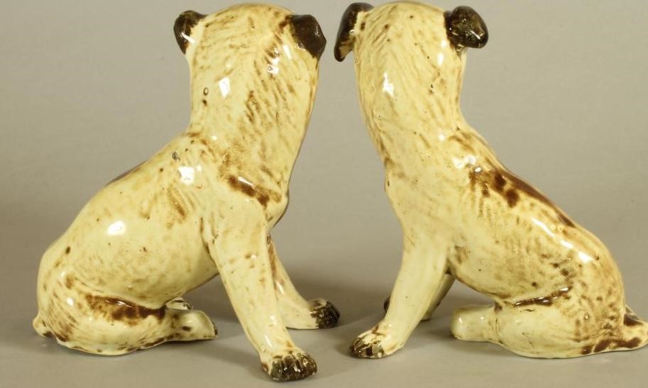 A MATCHED PAIR OF CONTINENTAL CREAMWARE SLIP CAST MODELS OF PUGS Image