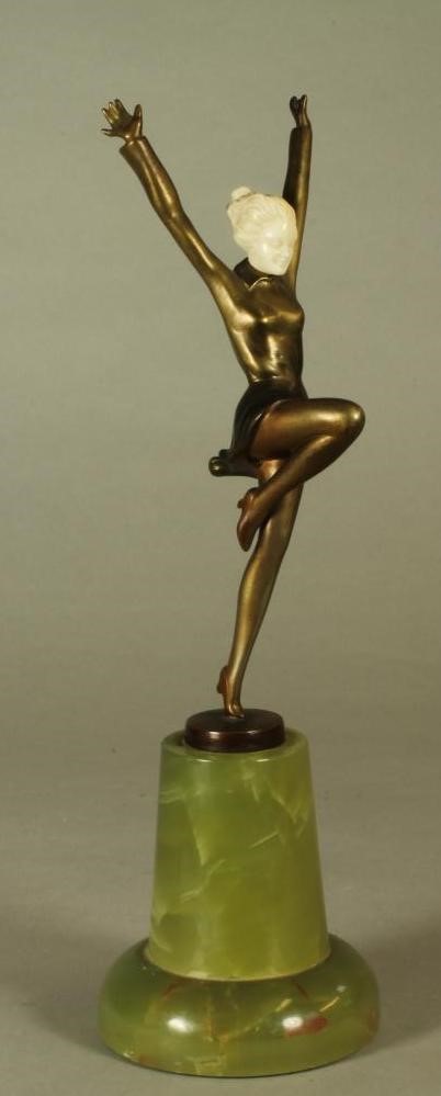 AN ART DECO BRONZE FIGURE OF A YOUNG FEMALE with carved ivory head Image