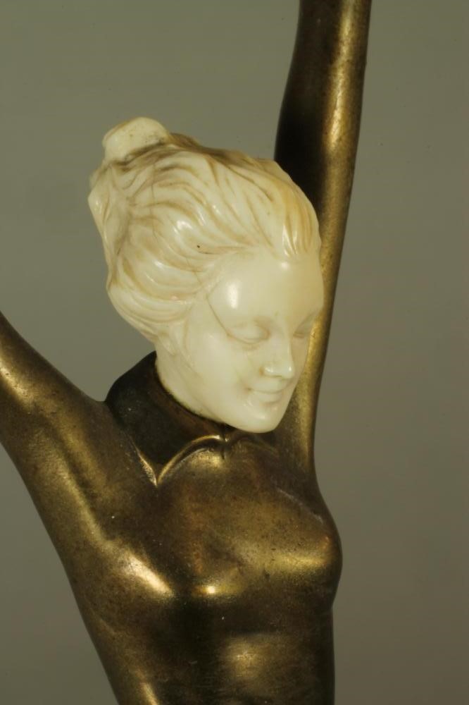 AN ART DECO BRONZE FIGURE OF A YOUNG FEMALE with carved ivory head Image