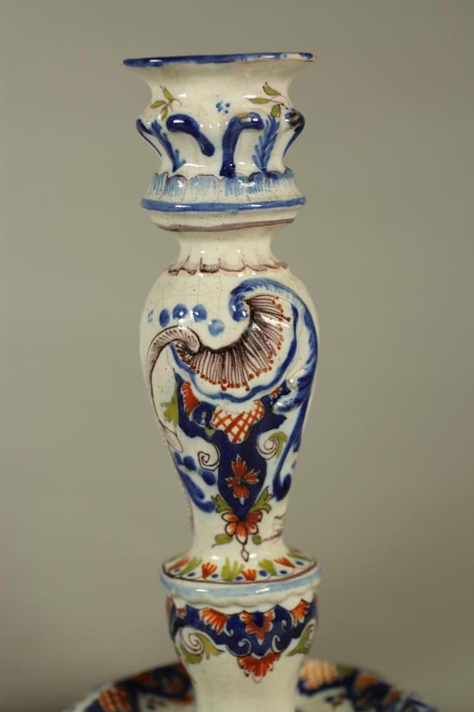 A COMPOSITE PAIR OF FRENCH FAIENCE CANDLESTICKS Image
