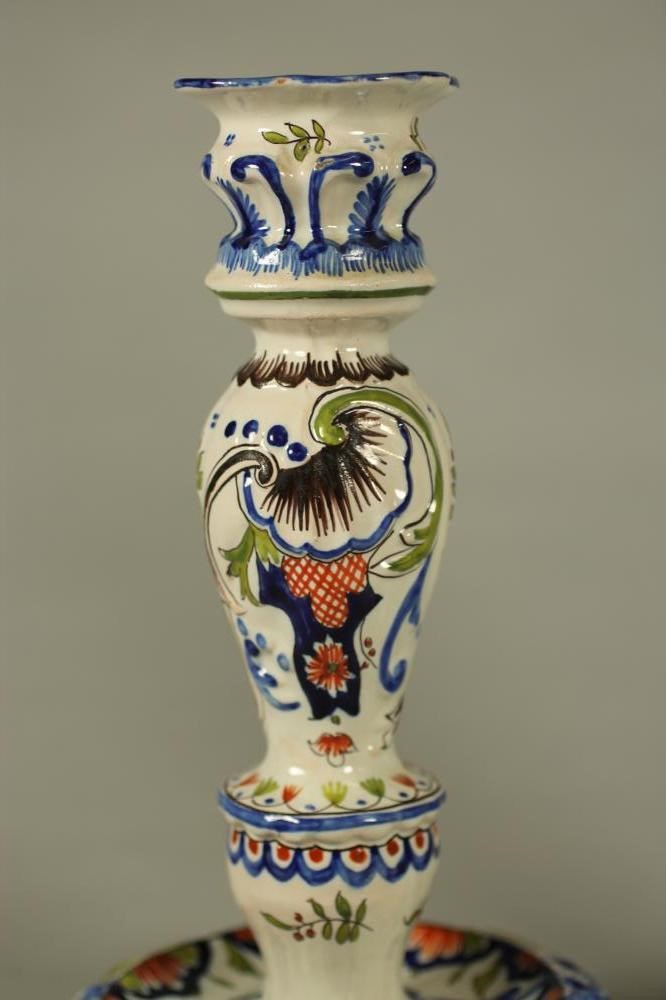 A COMPOSITE PAIR OF FRENCH FAIENCE CANDLESTICKS Image