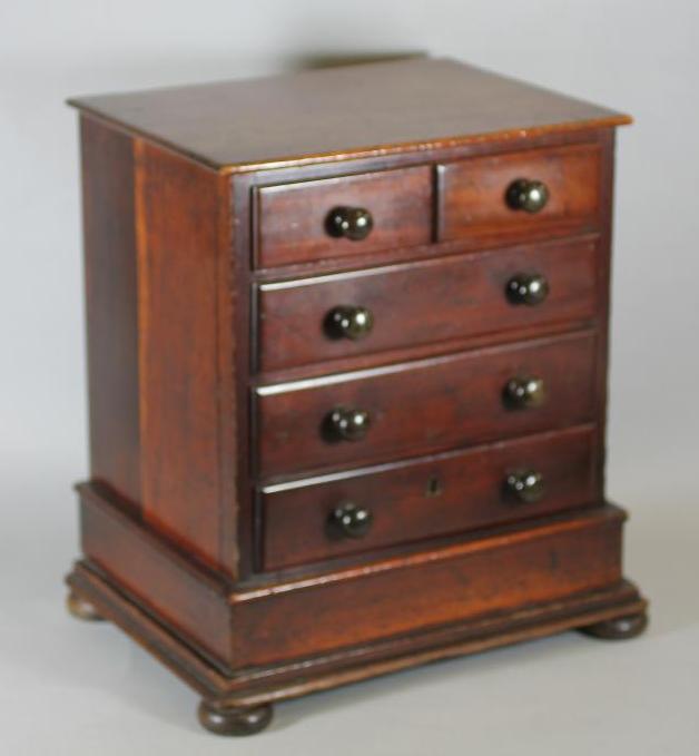 A VICTORIAN MAHOGANY MINIATURE CHEST of two short and three long drawers with turned wood handles Image
