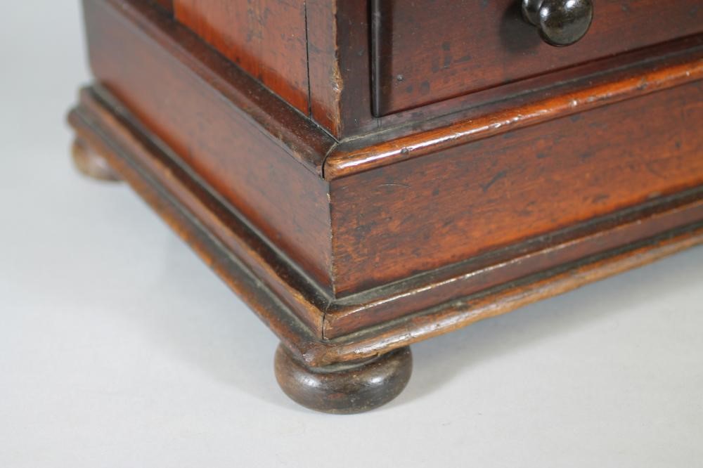 A VICTORIAN MAHOGANY MINIATURE CHEST of two short and three long drawers with turned wood handles Image