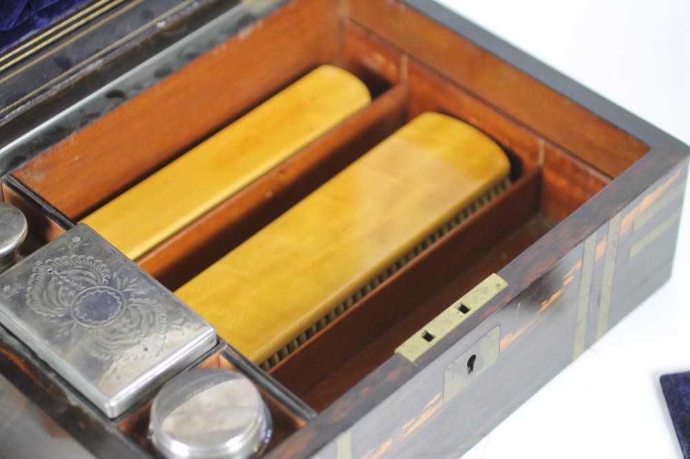 AN EARLY VICTORIAN COROMANDEL TRAVELLING DRESSING BOX of plain oblong form with inlaid brass Image