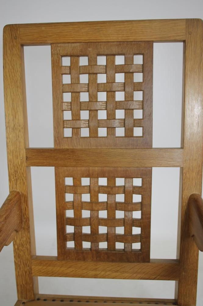 A ROBERT THOMPSON OAK ROCKING CHAIR Image