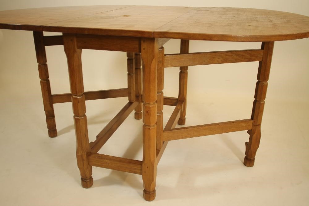 A MALCOLM PIPES ADZED OAK DINING SUITE comprising gateleg table Image