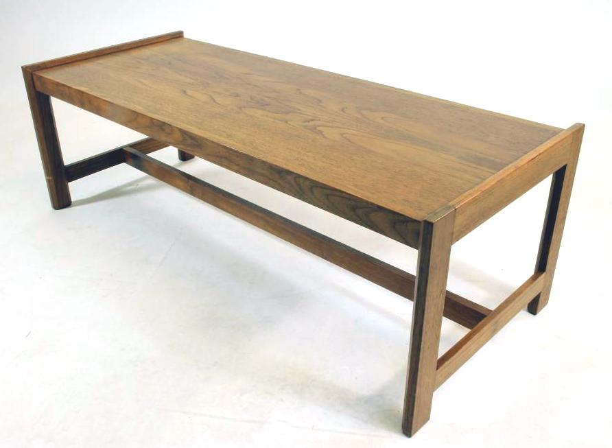 A GORDON RUSSELL TEAK COFFEE TABLE of oblong form with raised ends Image
