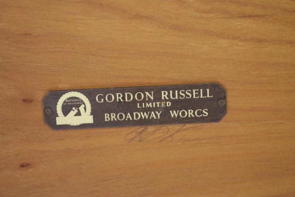 A GORDON RUSSELL TEAK COFFEE TABLE of oblong form with raised ends Image