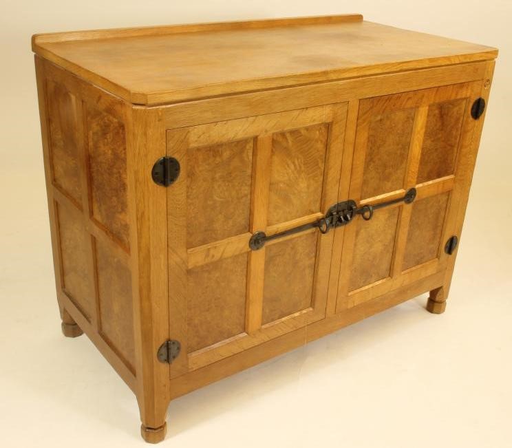 A MALCOLM PIPES ADZED OAK AND BURR OAK SIDE CABINET of canted multi panelled form Image