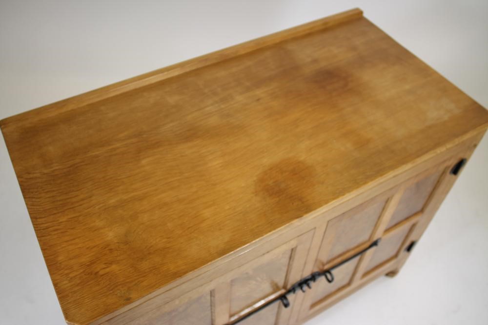 A MALCOLM PIPES ADZED OAK AND BURR OAK SIDE CABINET of canted multi panelled form Image