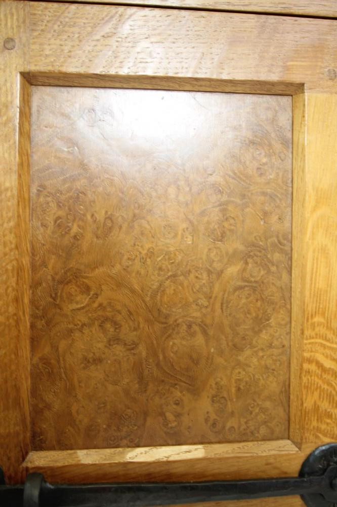 A MALCOLM PIPES ADZED OAK AND BURR OAK SIDE CABINET of canted multi panelled form Image