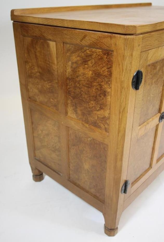 A MALCOLM PIPES ADZED OAK AND BURR OAK SIDE CABINET of canted multi panelled form Image