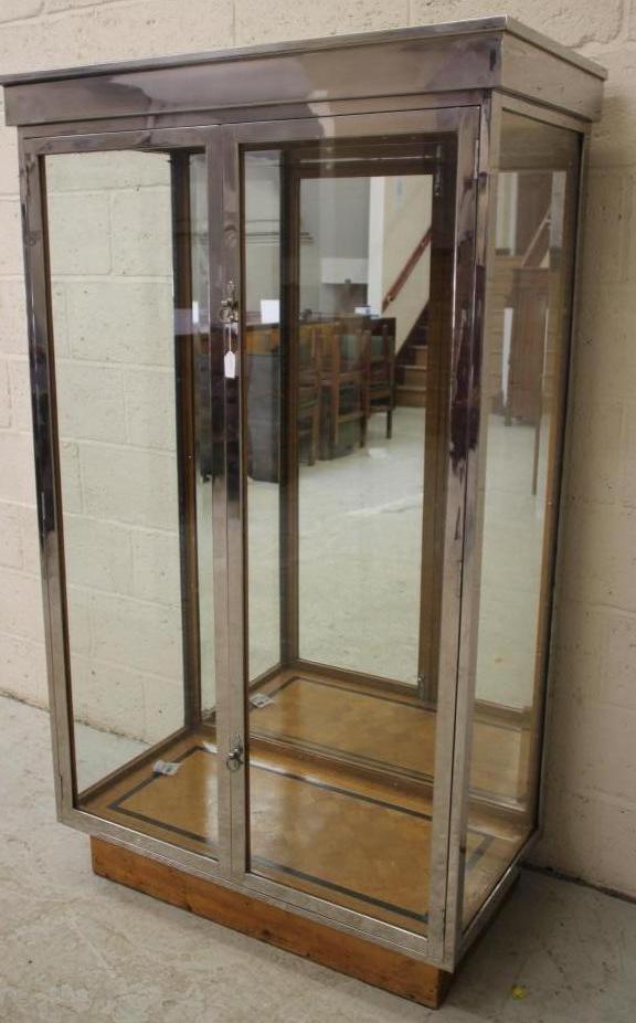 AN ART DECO OAK DISPLAY CABINET of oblong form with two doors having ring handles Image