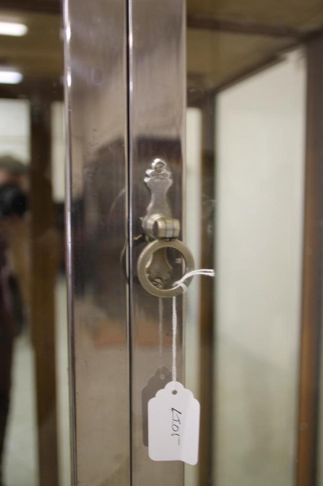 AN ART DECO OAK DISPLAY CABINET of oblong form with two doors having ring handles Image