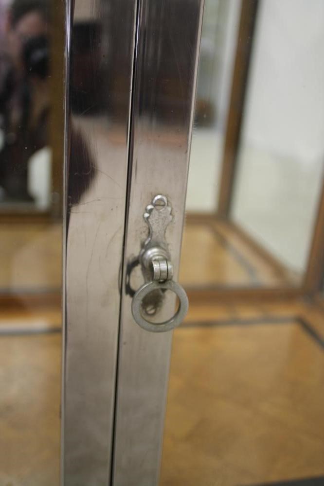 AN ART DECO OAK DISPLAY CABINET of oblong form with two doors having ring handles Image