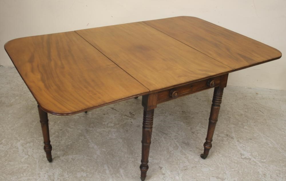 A REGENCY MAHOGANY DROP LEAF DINING TABLE of rounded oblong form with reeded edged top Image