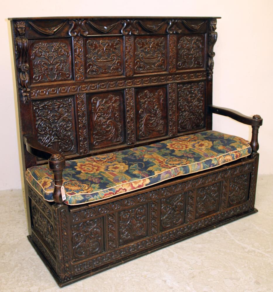 A VICTORIAN CARVED OAK PANELLED SETTLE Image