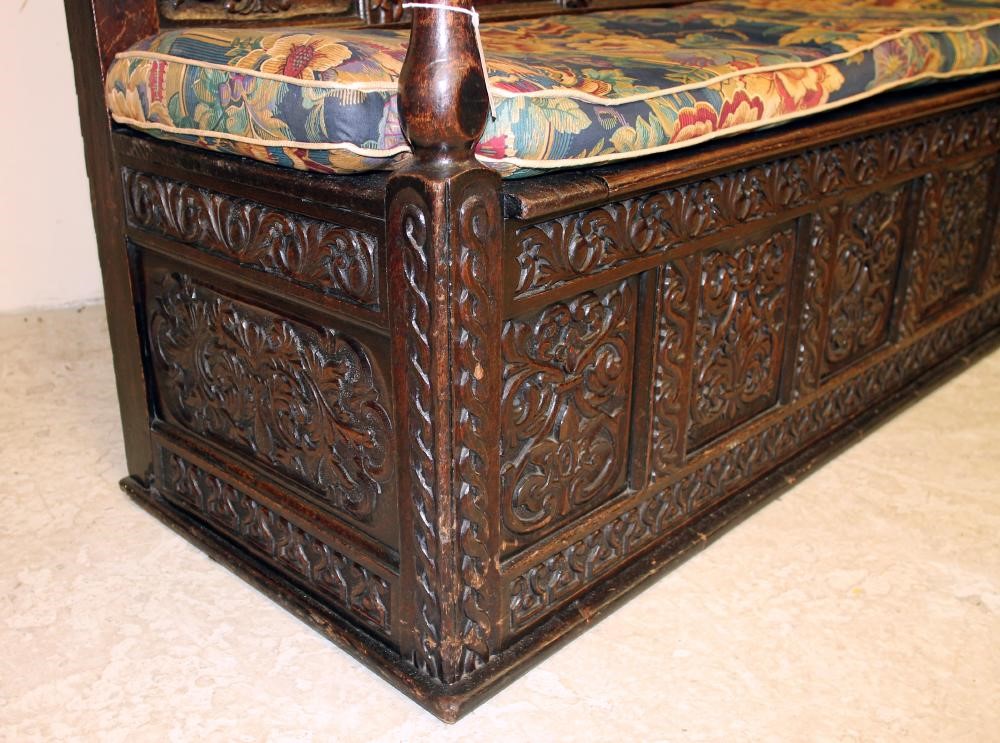 A VICTORIAN CARVED OAK PANELLED SETTLE Image