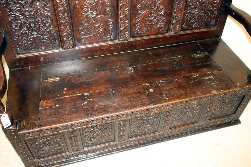 A VICTORIAN CARVED OAK PANELLED SETTLE Image