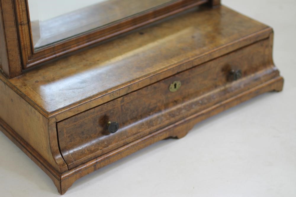 A GEORGIAN WALNUT AND FEATHER BANDED TOILET MIRROR Image