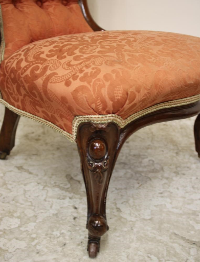 A LADY'S VICTORIAN WALNUT SALON CHAIR of spoonback form button upholstered in terracotta brocade Image