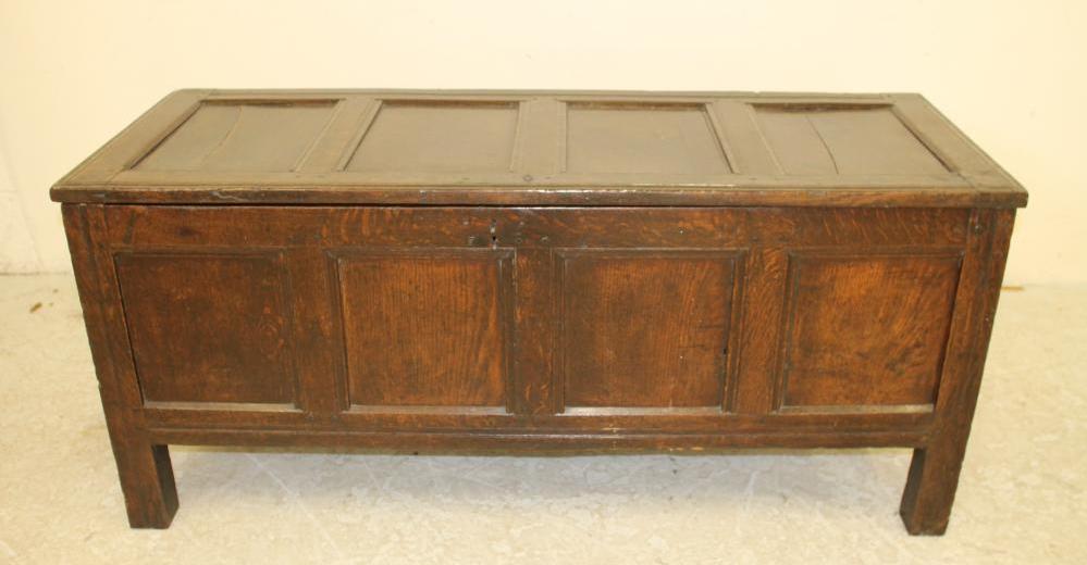 AN OAK PANELLED COFFER Image