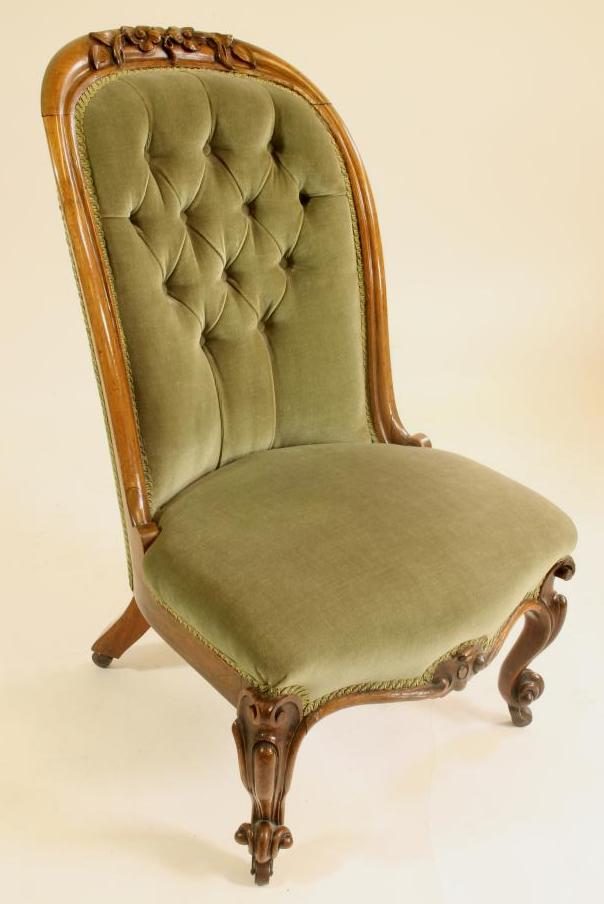 A VICTORIAN WALNUT FRAMED NURSING CHAIR button upholstered in pale green dralon Image