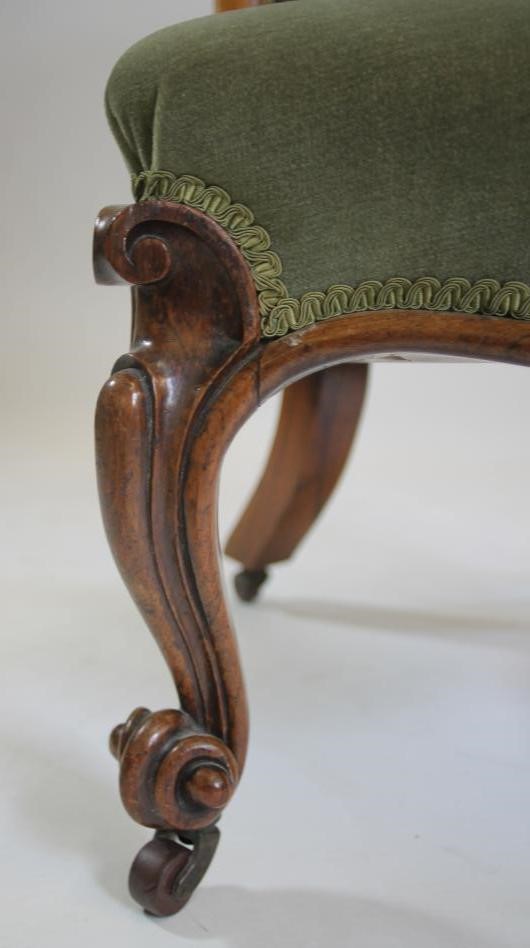 A VICTORIAN WALNUT FRAMED NURSING CHAIR button upholstered in pale green dralon Image