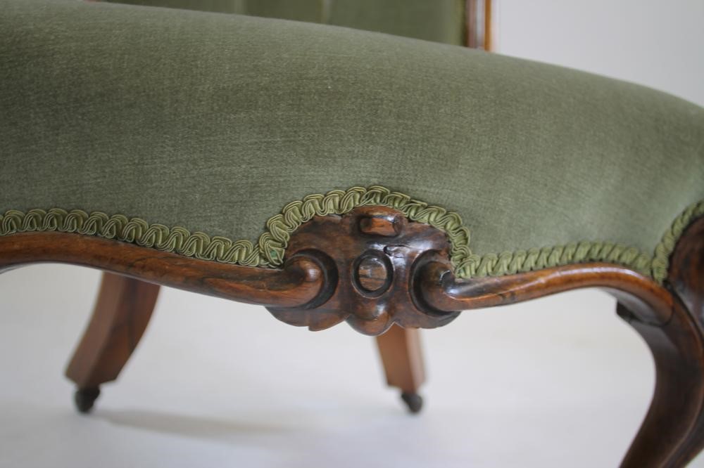 A VICTORIAN WALNUT FRAMED NURSING CHAIR button upholstered in pale green dralon Image