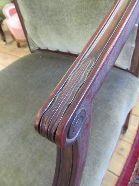A REGENCY MAHOGANY ELBOW CHAIR upholstered in green velvet Image