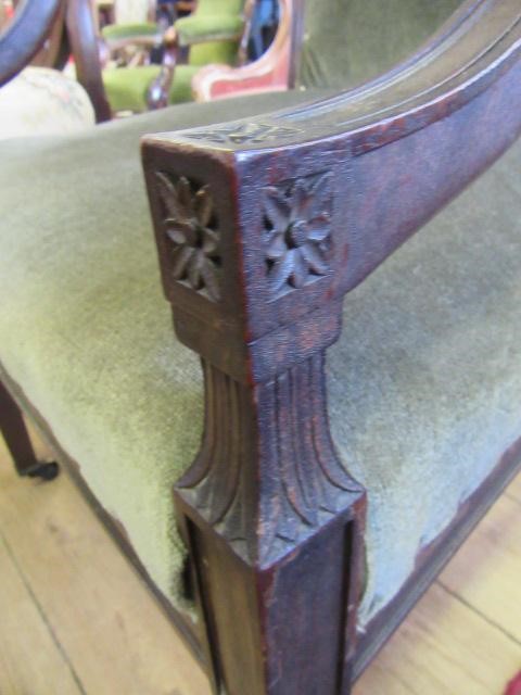 A REGENCY MAHOGANY ELBOW CHAIR upholstered in green velvet Image