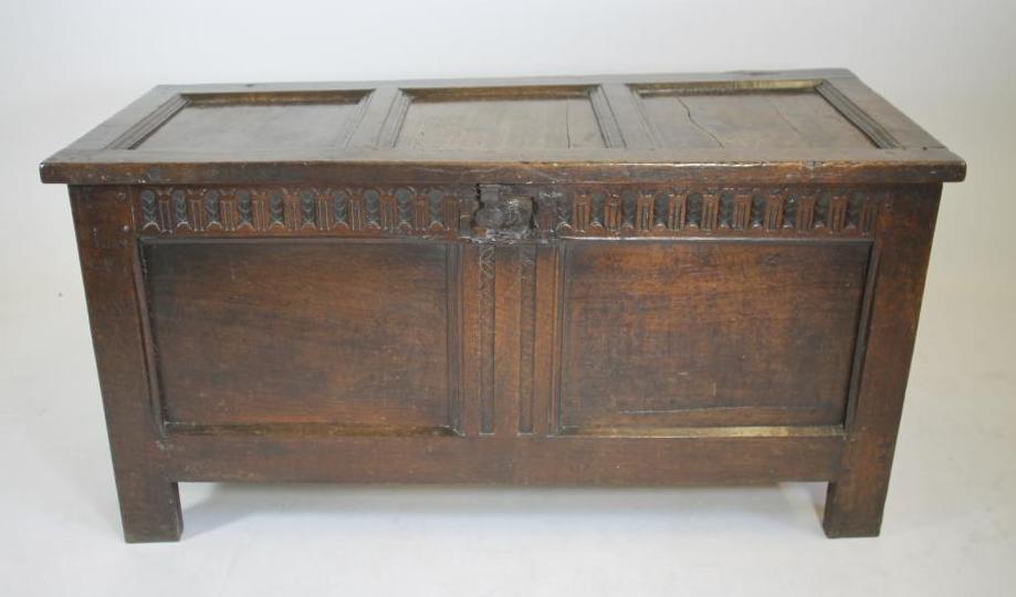 AN OAK PANELLED COFFER Image