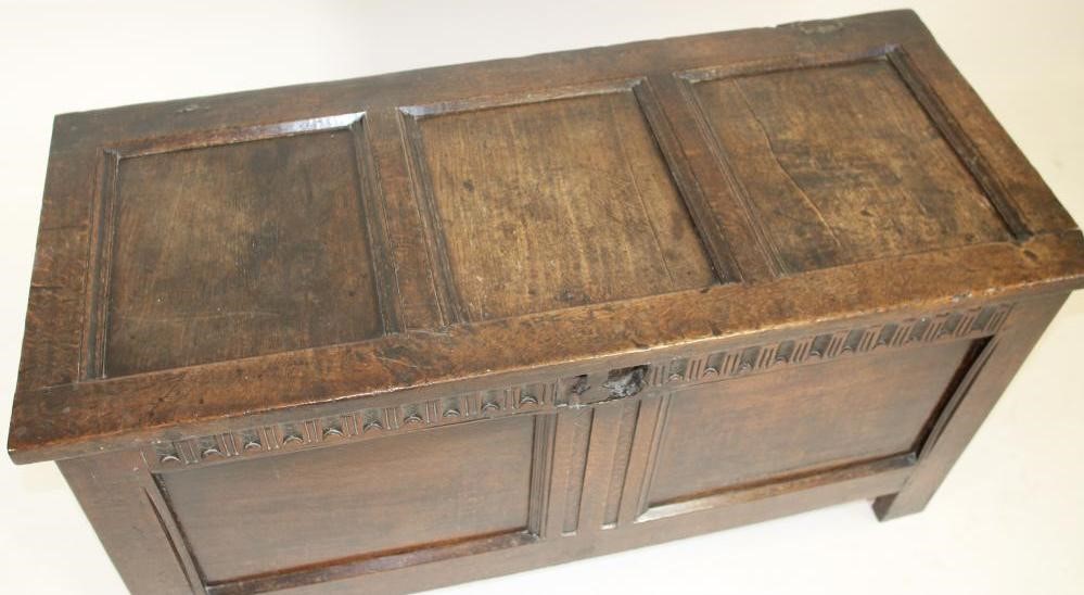 AN OAK PANELLED COFFER Image