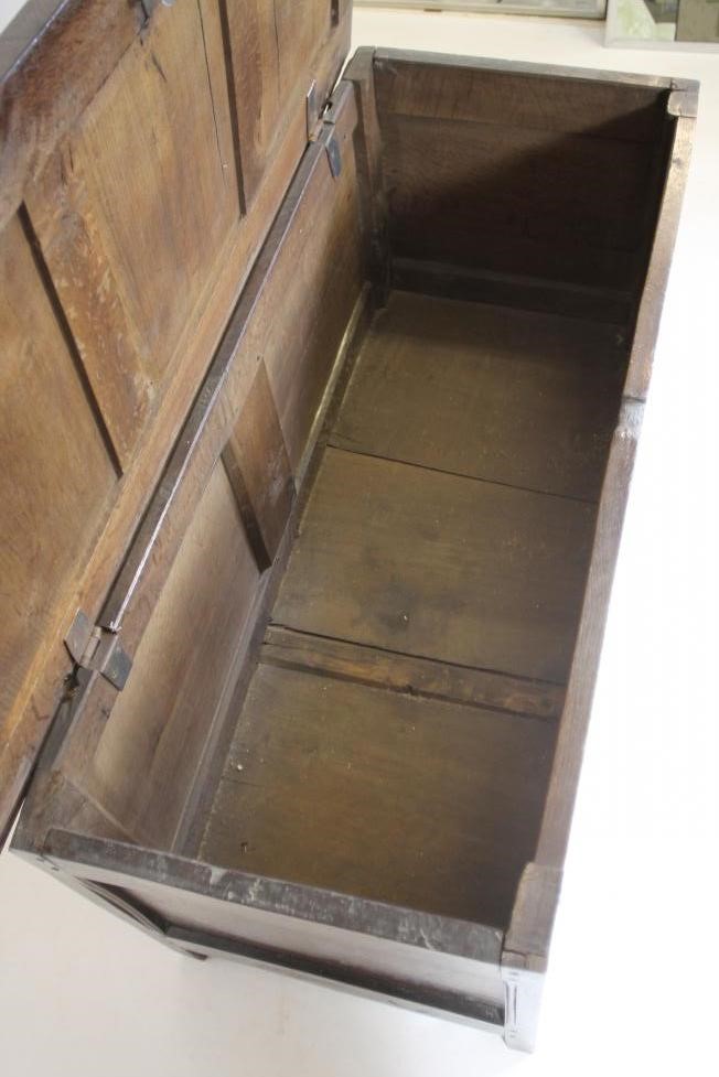 AN OAK PANELLED COFFER Image