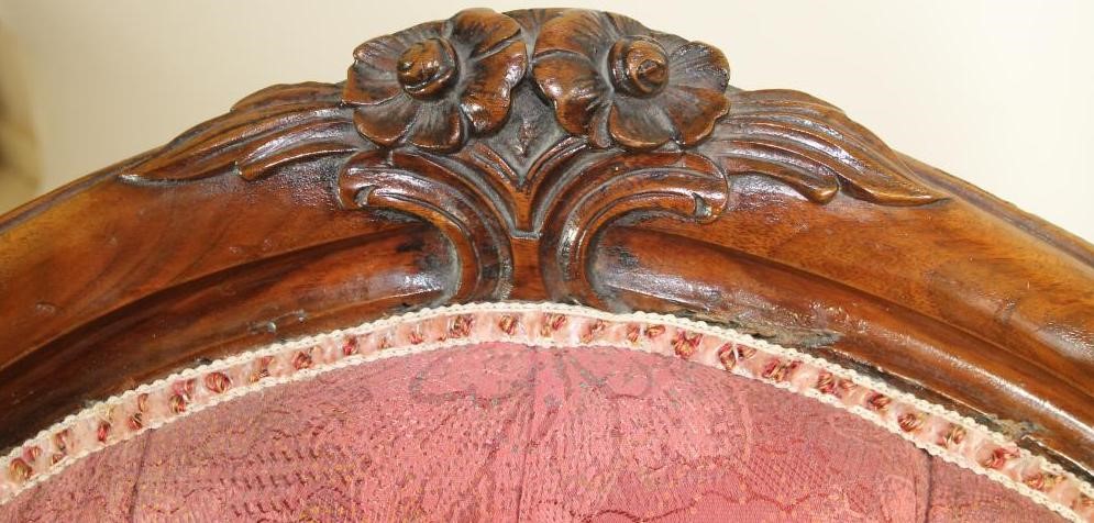 A VICTORIAN WALNUT FRAMED ARM CHAIR of spoonback form button upholstered in raspberry weave Image