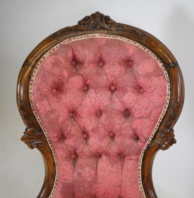 A VICTORIAN WALNUT FRAMED ARM CHAIR of spoonback form button upholstered in raspberry weave Image