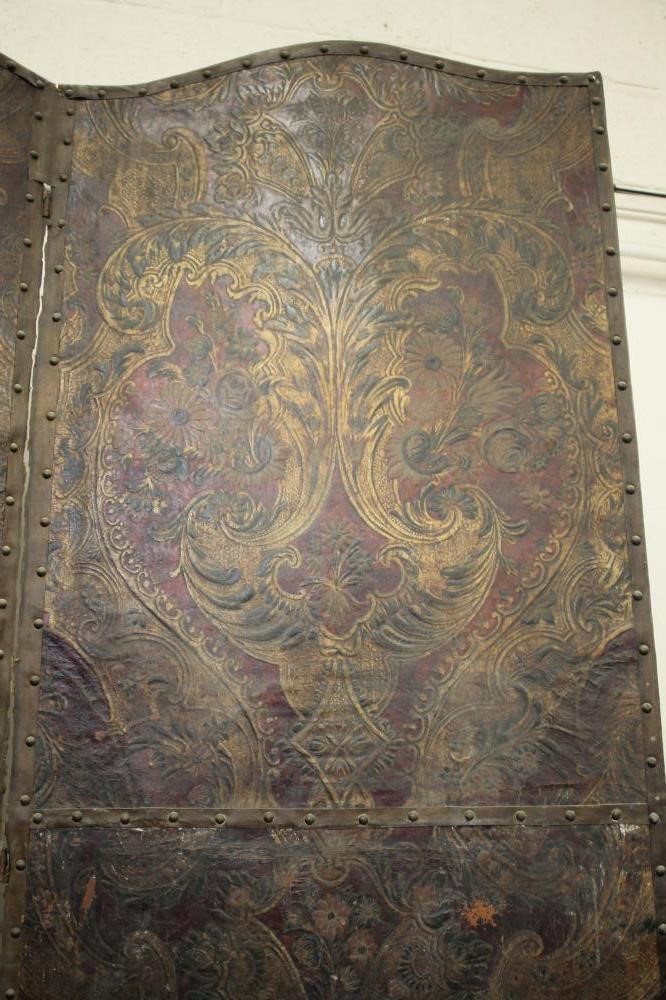 A FOUR FOLD EMBOSSED LEATHER ROOM SCREEN Image