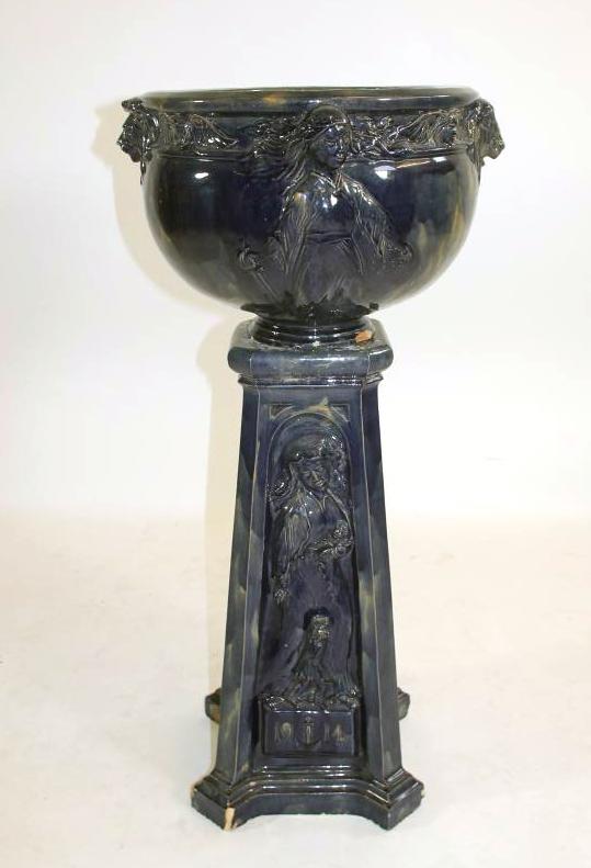 A CONTINENTAL HEAVY EARTHENWARE JARDINIERE AND STAND Image