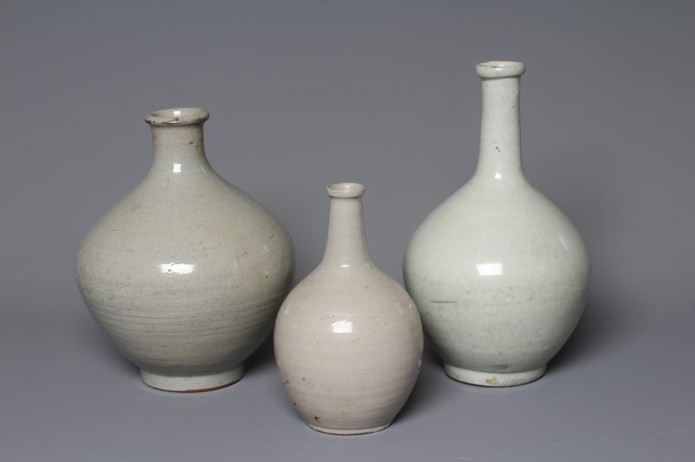 THREE CHINESE STONEWARE CELADON GLAZED BALUSTER VASES, unmarked, 10 1/2", 9" & 7 1/2" high (Est. Image