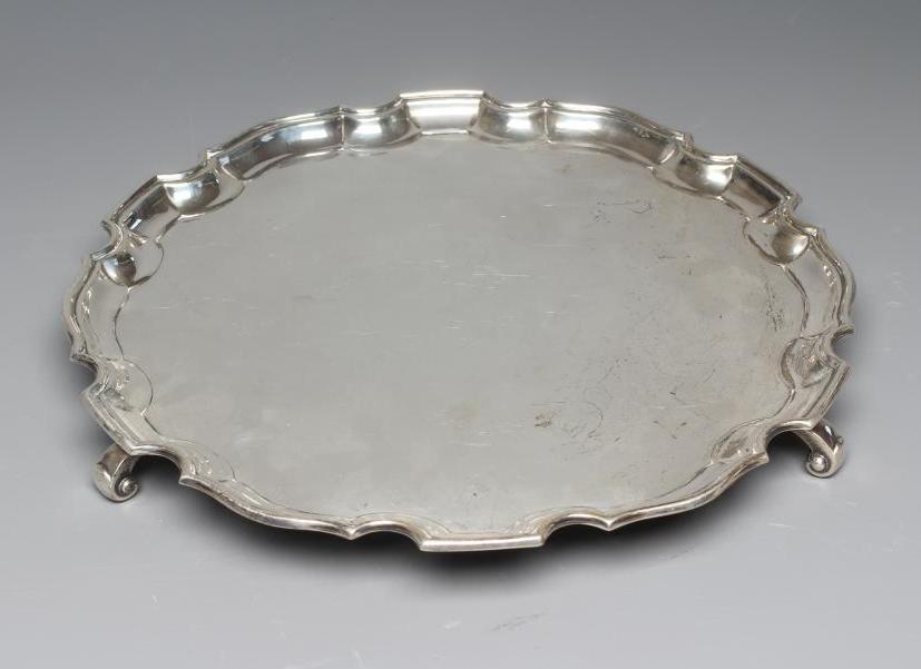 A GEORGE V SILVER SALVER by Adie Brothers Ltd., Chester 1932, of shaped circular form with pie crust Image