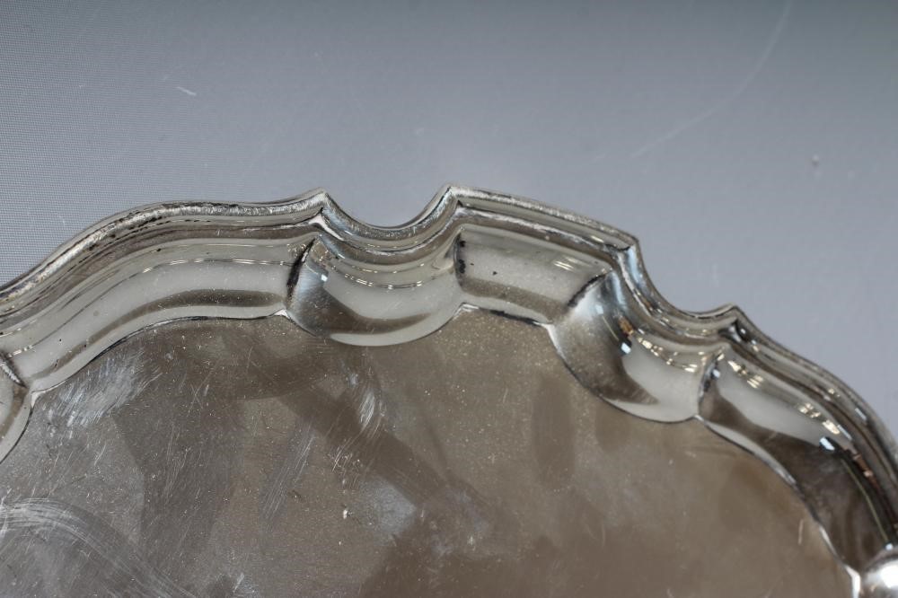 A GEORGE V SILVER SALVER by Adie Brothers Ltd., Chester 1932, of shaped circular form with pie crust Image