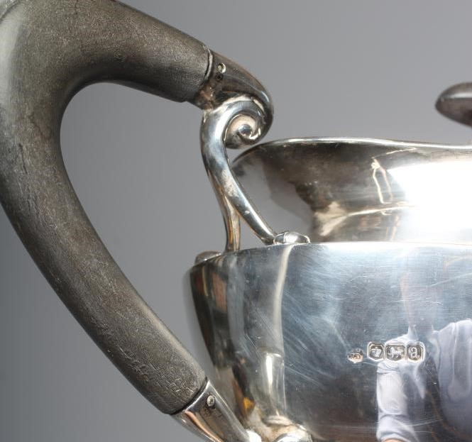 A GEORGE V SILVER ART NOUVEAU THREE PIECE TEA SERVICE by James Deakin & Sons Image