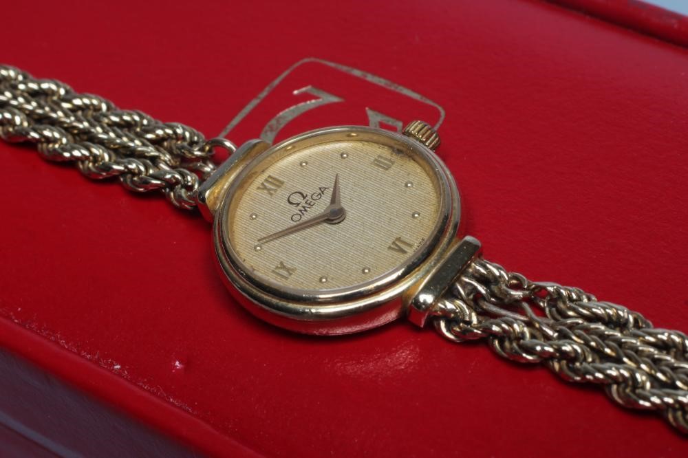 A LADY'S 9CT GOLD OMEGA WRISTWATCH Image