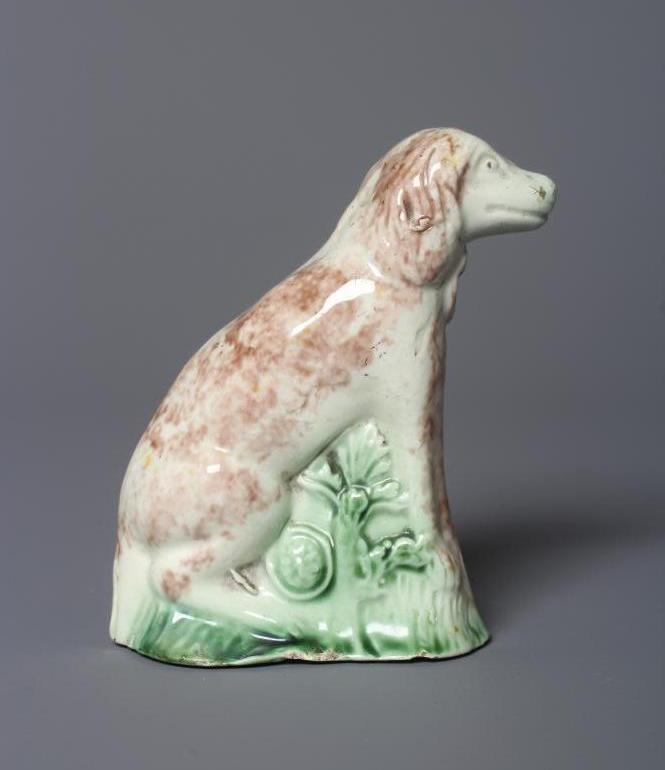 A WHIELDON TYPE CREAMWARE DOG, late 18th century, the seated slip-cast hound with brown sponged Image